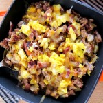 Skillet Breakfast Burritos with bacon, sausage, potatoes and eggs topped with cheese.